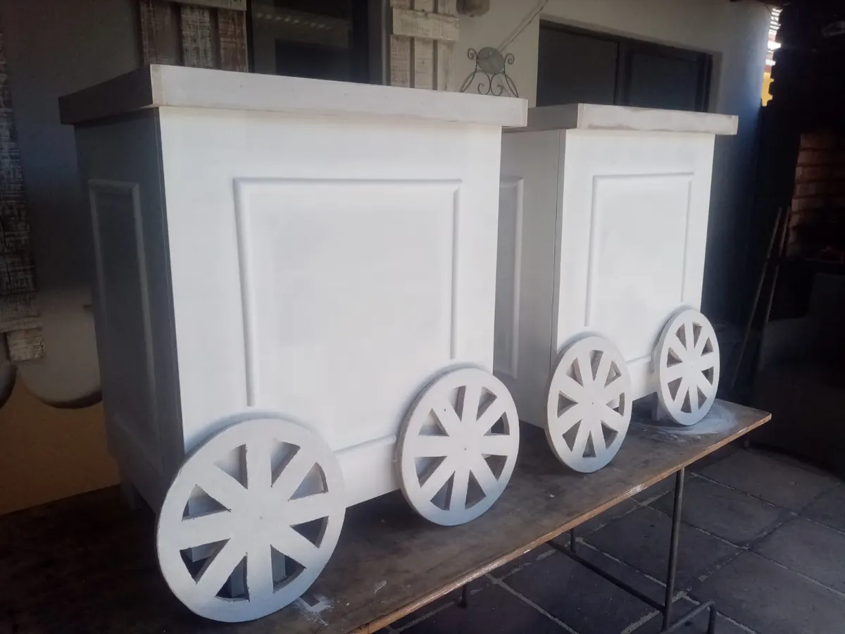 Two white candy carts with wheels